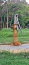 Old rusted metal handpump in a field Royalty Free Stock Photo