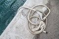 Old rusted mooring bollard with knotted nautical ropes. Selective focus. Los Gigantes, Tenerife Royalty Free Stock Photo