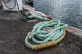 Old rusted mooring bollard with knotted nautical ropes. Selective focus. Los Gigantes, Tenerife Royalty Free Stock Photo
