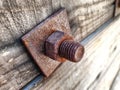 Old rusted nut and bolt on wood