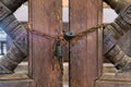 Old rusted padlocks and rusted chain on a wooden double door