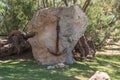 Old rusted ship`s anchor on a stone.