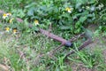 old rusted steel a mop, has expired. Was dropped on the ground by the road in the grass Rusty old iron, recycle