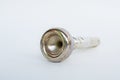 Old rusted trumpet mouthpiece on white Royalty Free Stock Photo