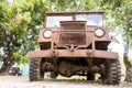 An old rusted wartime Blitz truck left under some trees