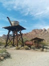 Old, rusted water tower and truck in the desert