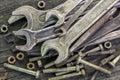 Old,rusted wrenches bolts and nuts on table