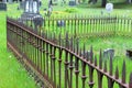 Old rusted wrought iron fencing around family plot in cemetery