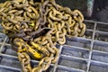 Rusty yellow chain on ground