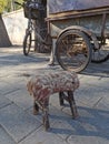 Old rustic antique chair in the street with a vintage bicycle in the background