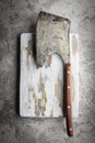 Old rustic axe for meat on a wooden board Royalty Free Stock Photo