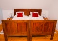Old rustic bed in modern apartment Royalty Free Stock Photo