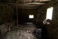 Old rustic clay cowshed interior with window