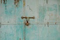 Old rustic door with blue peeling paint, rusty hinges, a  padlock, in Mandawa haveli Rajasthan India Royalty Free Stock Photo