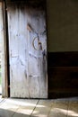 Old, rustic door open to the sunshine outside Royalty Free Stock Photo