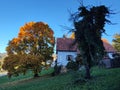 Old rustic farmhouse in fairytale picturesque golden autumn scenery in morning Royalty Free Stock Photo