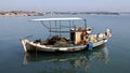 Old rustic fishing boat at the anchor off the coast, Katakolon, Greece