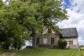 Old Rustic House Under a Large Tree Royalty Free Stock Photo
