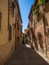 Old rustic mediterranean traditional house facade wall narrow alley lane road street in Toledo Castilla La Mancha Spain Royalty Free Stock Photo