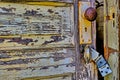 Old, rustic, partially open door with broken latch