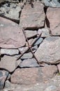 Old rustic rock wall. Stone wall with rusty metal cross detail. Historic old town wall in Porvoo Finland Royalty Free Stock Photo