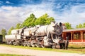Old rustic steam locomotive on station platform. Cloudy sky back Royalty Free Stock Photo
