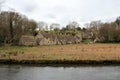 Old stone houses in english countryside and river Royalty Free Stock Photo