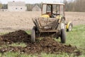 Old Rustic Tractor Delivering Manure.