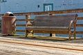 Old rustic vintage bench and rusty trash bin