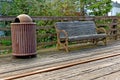 Old rustic vintage bench and rusty trash bin