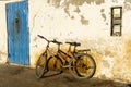 Old rustic vintage bicycle on the street near the color wall. Travel concept. Bike ride. Postcard Royalty Free Stock Photo