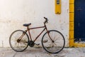 Old rustic vintage bicycle on the street near the color wall. Travel concept. Bike ride. Postcard Royalty Free Stock Photo