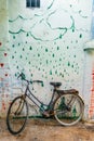 Old rustic vintage bicycle on the street near the color wall. Travel concept. Bike ride. Postcard Royalty Free Stock Photo