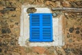 Old rustic window with blue closed shutters in Mallorca, Spain Royalty Free Stock Photo