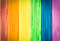 An old rustic wooden board with rainbow colors for gay pride. Ga Royalty Free Stock Photo