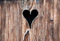 Old wooden door with a heart-shaped hole Royalty Free Stock Photo