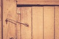 Old rustic wooden door locked with hook