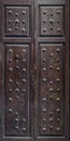 Old rustic wooden door with metal rivet