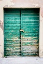 Old rustic wooden doors painted in green Royalty Free Stock Photo