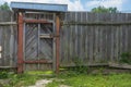 Old rustic wooden gate in natural village fence. Countryside rural scene, agrotourism Royalty Free Stock Photo