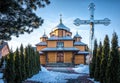 Old rustic wooden orthodox christian church and the statue of the Virgin Mary Royalty Free Stock Photo