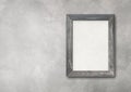 Old rustic wooden picture frame hanging on a concrete wall. Horizontal banner Royalty Free Stock Photo