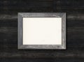 Old rustic wooden picture frame hanging on a light blue wall Royalty Free Stock Photo