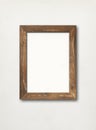Old rustic wooden picture frame hanging on a white wall Royalty Free Stock Photo