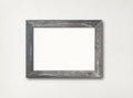 Old rustic wooden picture frame hanging on a white wall Royalty Free Stock Photo