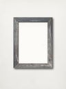 Old rustic wooden picture frame hanging on a white wall Royalty Free Stock Photo