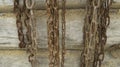 Old chains hang on a wooden log wall