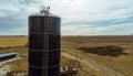 Farm grain silo in field Royalty Free Stock Photo