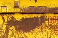 Old rusting metal skip container with yellow pealing paint Royalty Free Stock Photo