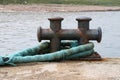 Old Rusting Steel Mooring Bollard and Rope at a Coastal Location Royalty Free Stock Photo